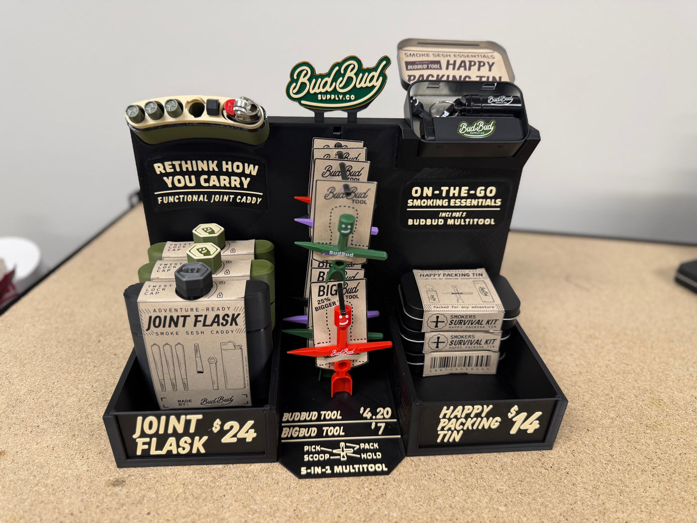 BudBud counter displays stocked with Joint Flasks, Happy Packing Tins and BudBud tools